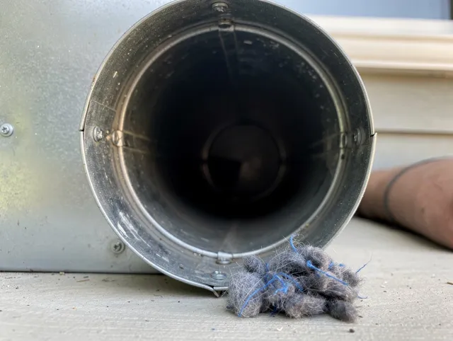 East Hampton Dryer Vent Cleaning technician using specialized equipment to clear severe dryer vent blockage in East Hampton